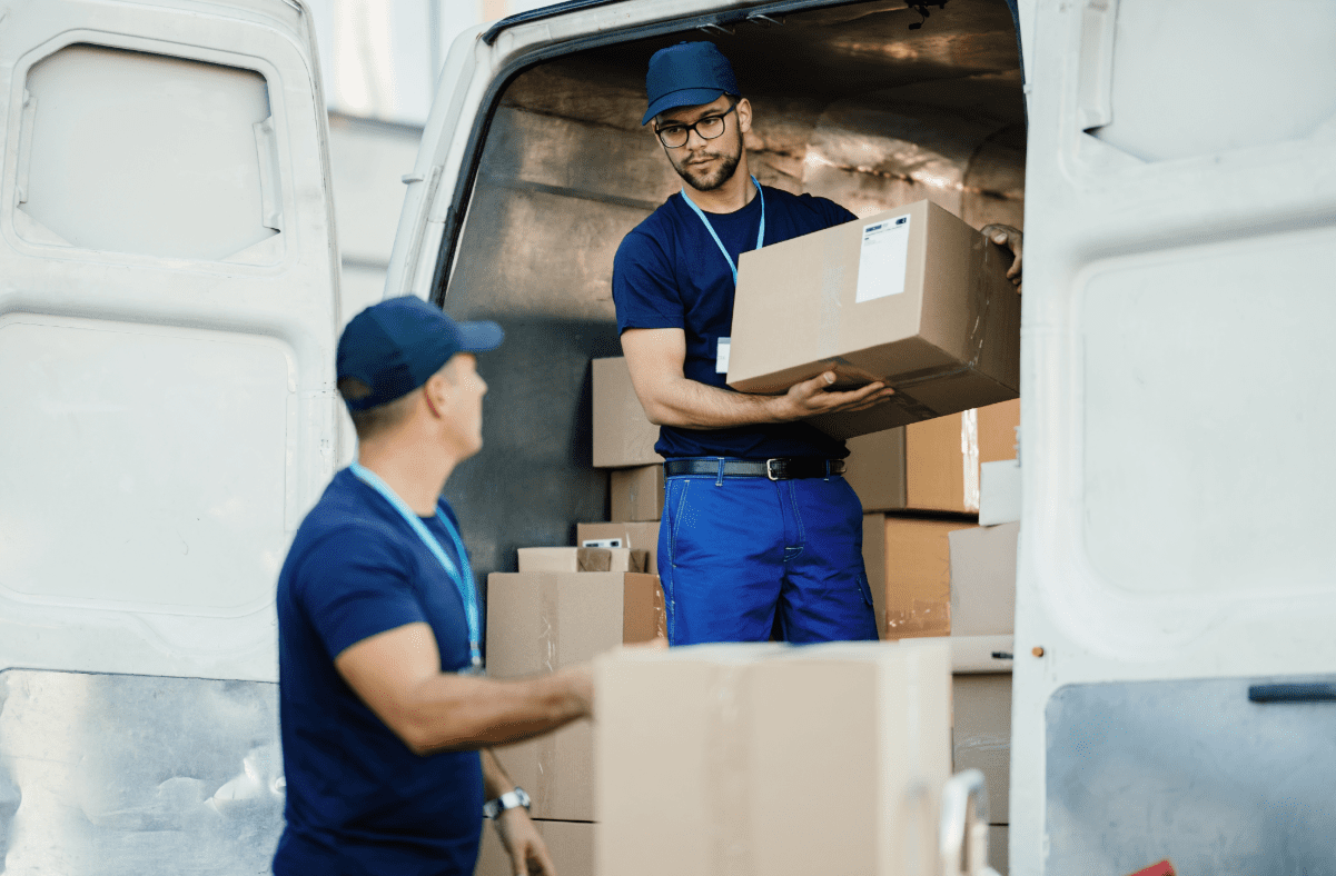 Men loading boxes of goods into van while discussing inland marine insurance