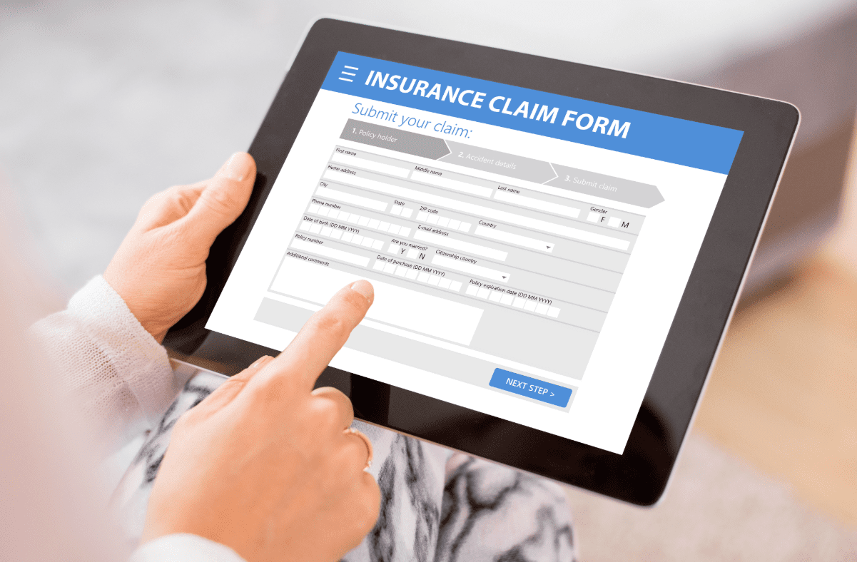 Person filing out insurance claim form on a tablet