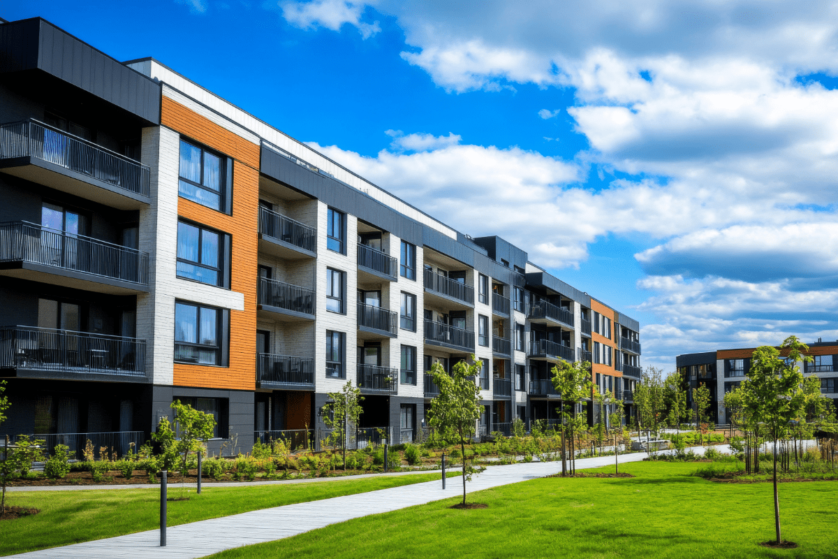 Exterior photo of condo buildings and landscaping