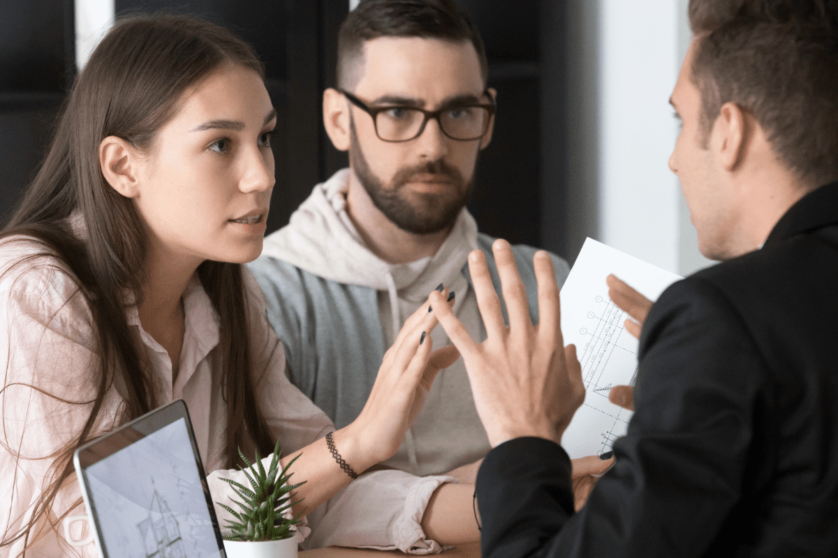 Couple discussing insurance with insurance agent