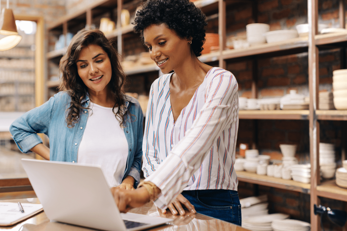 Two women business owners reviewing insurance information on their laptop