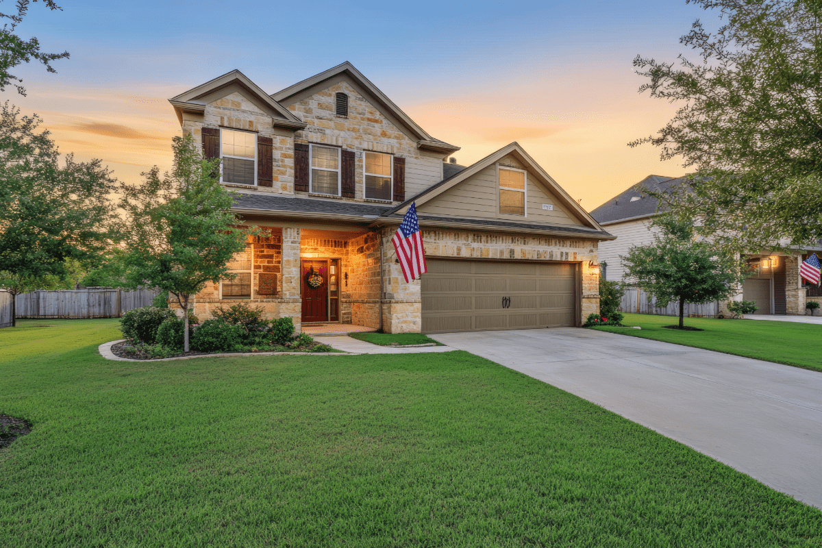 Texas stone home with American flag flyinf