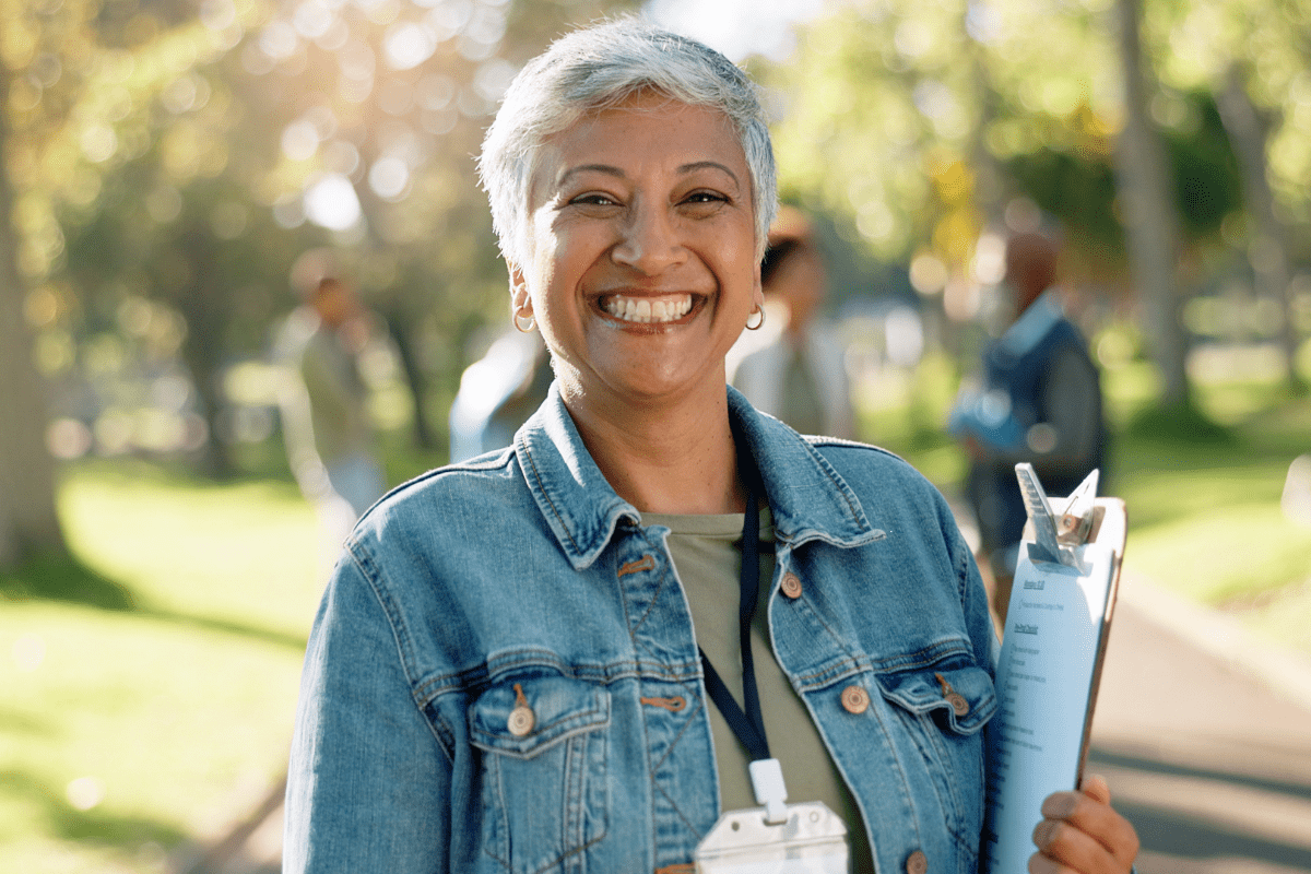 Woman holding clipboard leading a nonprofit team