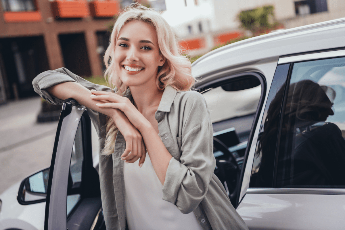 Woman standing at car door